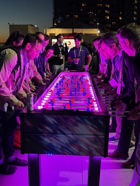 A photo of attendees playing foosball at Kraken event